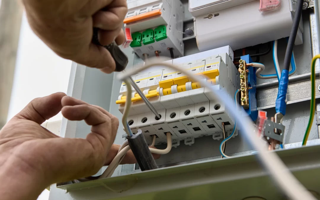 an electrician working on a home electrical panel