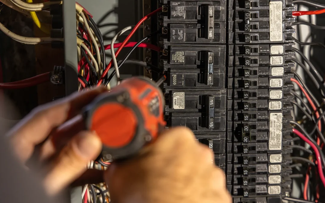 Socket Doctors electrician installing an electrical circuit breaker.
